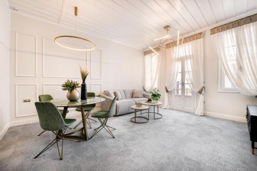 uma sala de estar com uma mesa e um sofá em Mavrogenous Luxury Apartments em Nafplio
