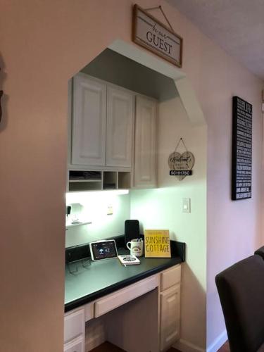 a kitchen with white cabinets and a counter top at 1 mi to Dollywood mins to all attractions & GSMNP in Sevierville