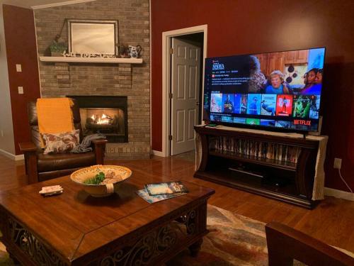 a living room with a fireplace and a flat screen tv at 1 mi to Dollywood mins to all attractions & GSMNP in Sevierville