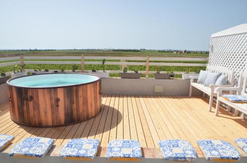 a hot tub on the deck of a house at GIARDINO del MARE in Petrosino
