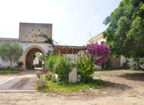 a building with a bunch of plants in a yard at GIARDINO del MARE in Petrosino