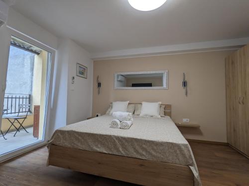 a bedroom with a bed with two towels on it at Olea Rooms Piran Old Town in Piran