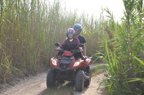 a man and woman riding a atv on a dirt road at GIARDINO del MARE in Petrosino