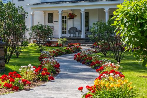 a garden of flowers in front of a house at The Barnstead Inn in Manchester Center