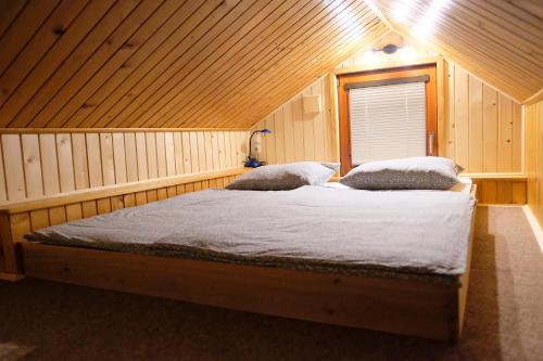 a bedroom with two beds in a attic at Wooden house Ažbe in Bled