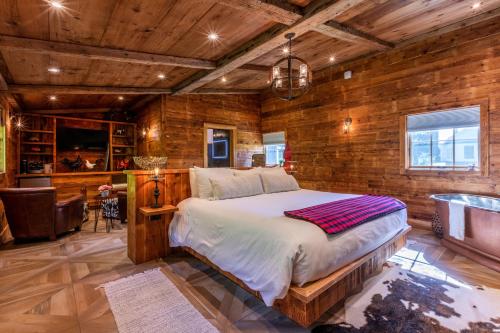 a bedroom with a bed and a wooden wall at The Barnstead Inn in Manchester Center