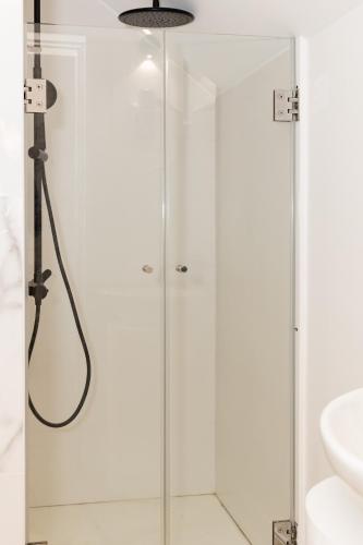 a shower with a glass door in a bathroom at Casa de Moledo Beach, Spa & Sauna in Moledo