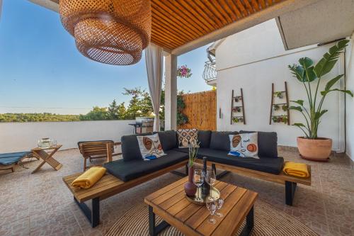 a living room with a couch and a table at Villa Oasis with private pool in Milna