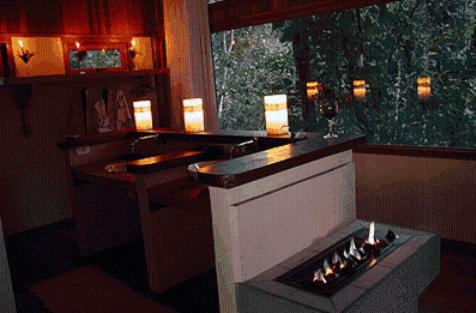 a bar with a fireplace in a room at Residencial Warabi in Visconde De Maua
