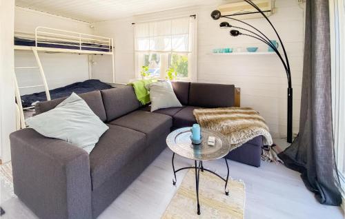a living room with a couch and a table at Cozy Home In Sexdrega With Lake View in Sexdrega