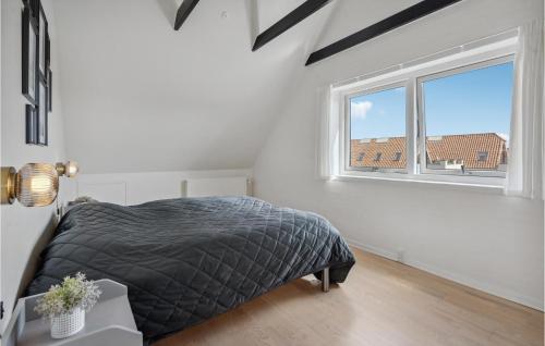 a white bedroom with a bed and a window at Stunning Apartment In Blvand With 1 Bedrooms And Wifi in Blåvand