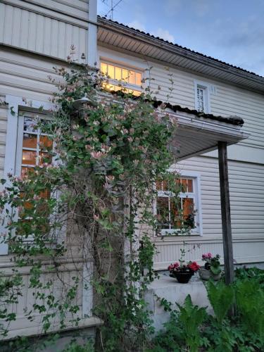 a house with a bunch of flowers on the side of it at Viva Apartment in Tallinn