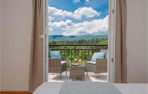 a bedroom with a view of a balcony with chairs at Beautiful Home In Kamen Most in Kamenmost