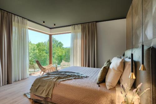 1 dormitorio con cama y ventana grande en Nicol Tireli, en Kršan