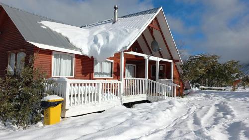 a house with snow on the front of it at Cabana Vista Nevada in Nevados de Chillan