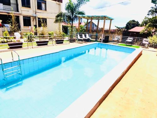 a large blue swimming pool in a building at Trendy apartments in Entebbe