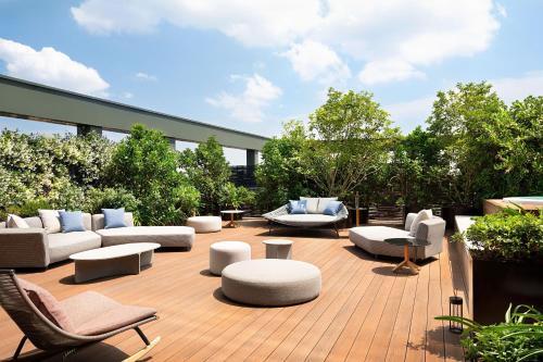 a patio with couches and chairs on a deck at The Westin Palace, Milan in Milan