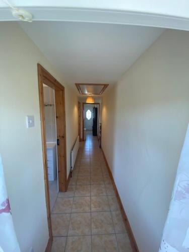 a hallway of a house with a hallway leading into a room at JMD Lodge - Self Catering Property in the heart of The Burren between Ballyvaughan, Lisdoonvarna, Doolin and Kilfenora in County Clare Ireland in Ballyvaughan