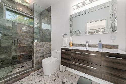 a bathroom with a toilet and a sink and a shower at Fabulous Beach Get Away - Brand New Beach House in Half Moon Bay