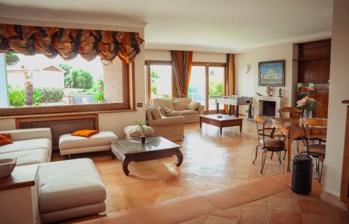 a living room filled with furniture and a table at Villa Attoni Di Canossa in Anzio