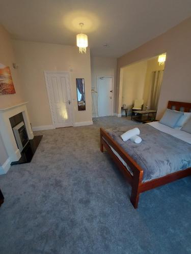 a large bedroom with a bed and a fireplace at Inn By The Sea, PORTSMOUTH in Portsmouth