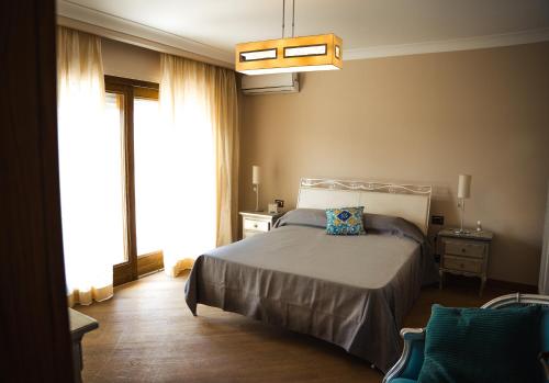 a bedroom with a bed and a large window at Villa Attoni Di Canossa in Anzio