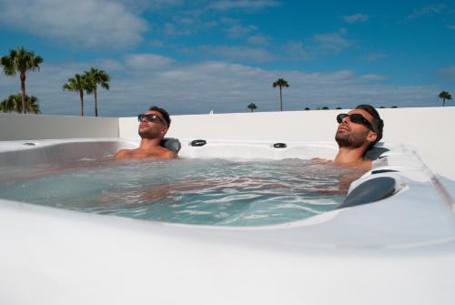 two men in a bath tub in the water at MAR BIANCO - Gay Men Only in Maspalomas