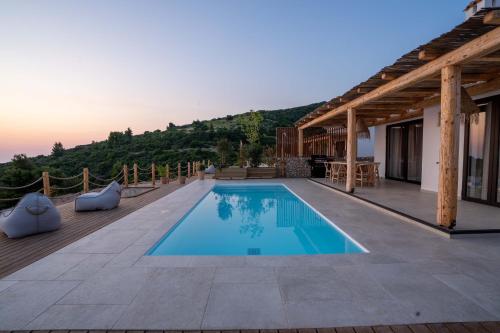 a villa with a swimming pool on a roof at Eunoia Porto Katsiki in Áyios Nikólaos Nirás