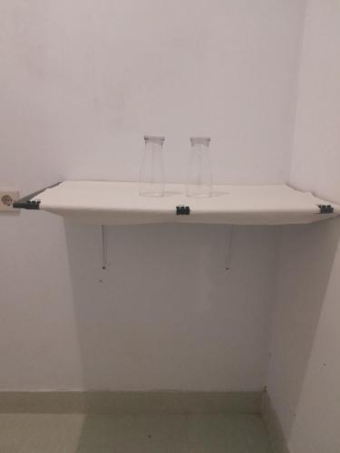 two glasses sitting on a shelf in a room at Mango Homestay in Sekotong