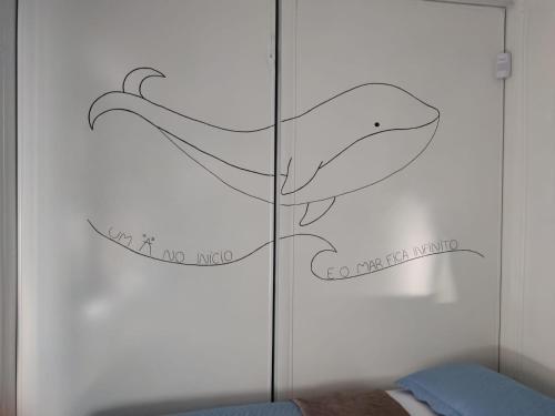 a bedroom with a wall with a whale decal at Maga hospedagem in Penha