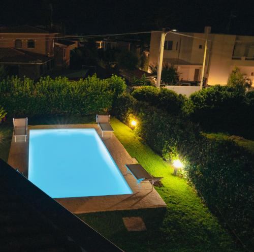 a swimming pool in a backyard at night at Villa Attoni Di Canossa in Anzio