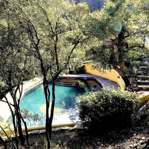 a pool of water in a park with trees at CASA PAVÃO (SALGADINHO - SELÃO DA EIRA) in São Teotónio
