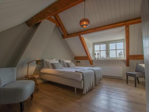 een slaapkamer met een bed, een stoel en een raam bij Hemels Helleke in Oosterhout