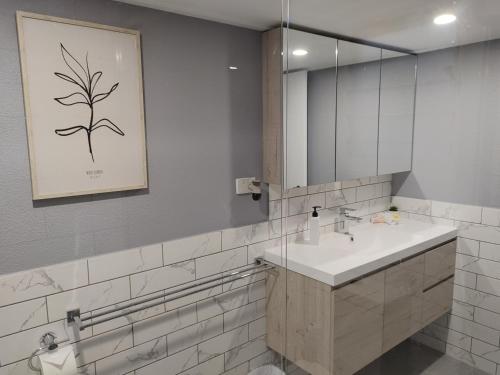 y baño con lavabo y espejo. en Cozy Bedroom with Ensuite - Amazing City Location en Townsville