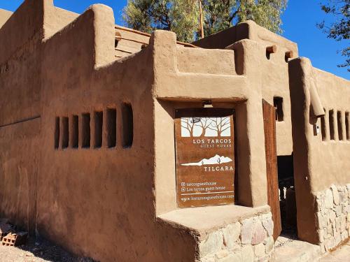 a building in the desert with a sign in it at Los tarcos Guest House TILCARA LOFT in Tilcara