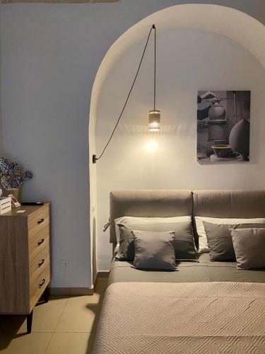 a bedroom with a bed and a dresser at Via Caputo 51 in Grottaglie
