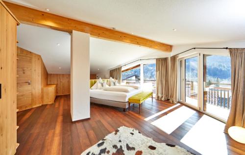 a bedroom with a bed and a large window at Das Gsteig in Garmisch-Partenkirchen