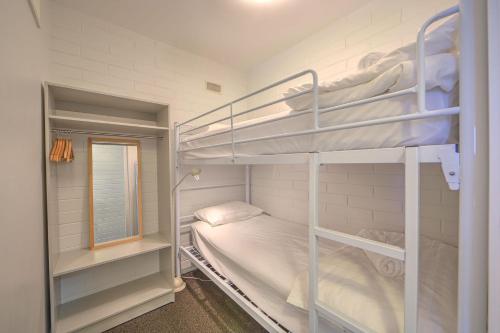 a bedroom with two bunk beds and a window at Snow Ski Apartments 19 in Falls Creek