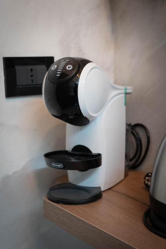 a black and white coffee maker sitting on a shelf at Lovely homes in Genova