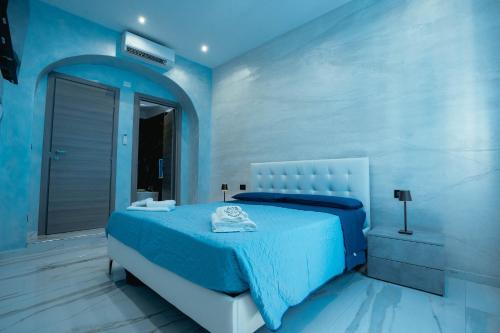 a blue bedroom with a bed and a window at Lovely homes in Genova