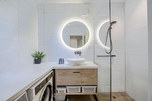 a white bathroom with a sink and a mirror at Snow Ski Apartments 23 in Falls Creek