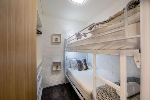a small room with two bunk beds in it at Snow Ski Apartments 23 in Falls Creek