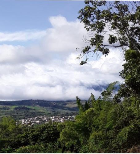 a view of a city from a hill with clouds at Casa La Aurora "Posada" in Restrepo