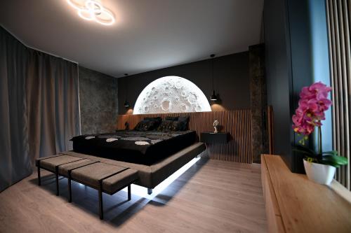 a bedroom with a bed and a table and flowers at CLOVER - Moonlight in Sarajevo