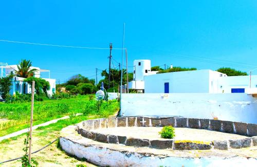 a view of a building with a stone wall at ANCIENT MEROPIA - Les jardins des muses in Apollonia