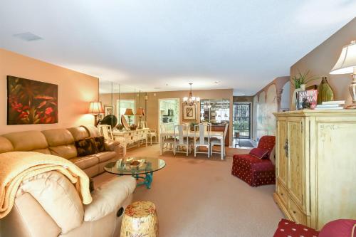 ein Wohnzimmer mit einem Sofa und einem Tisch in der Unterkunft Fairway Oaks Villa Condo in Amelia Island