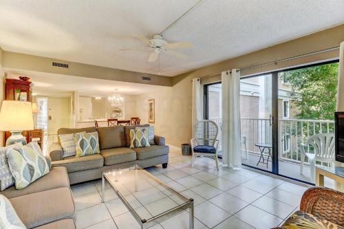 a living room with a couch and a table at Pool View Beachwood Condo in Fernandina Beach