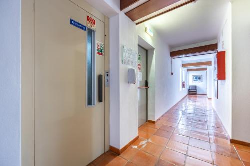 a hallway in a hospital with a tile floor at Hotel Residencial Salema in Salema