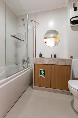a bathroom with a tub and a toilet and a sink at Terraço da Formosa in Silveira