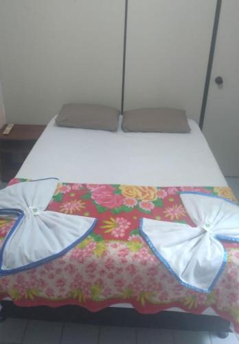 a bed with two pillows on top of it at POUSADA BRASIL RECIFE in Recife